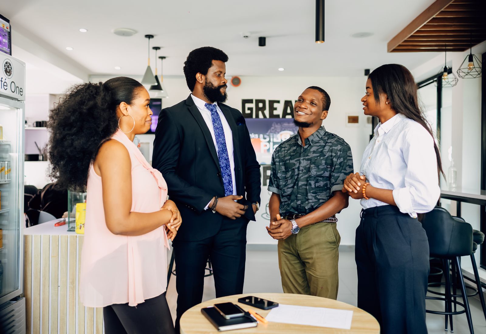 Four colleagues talking a project through in an office