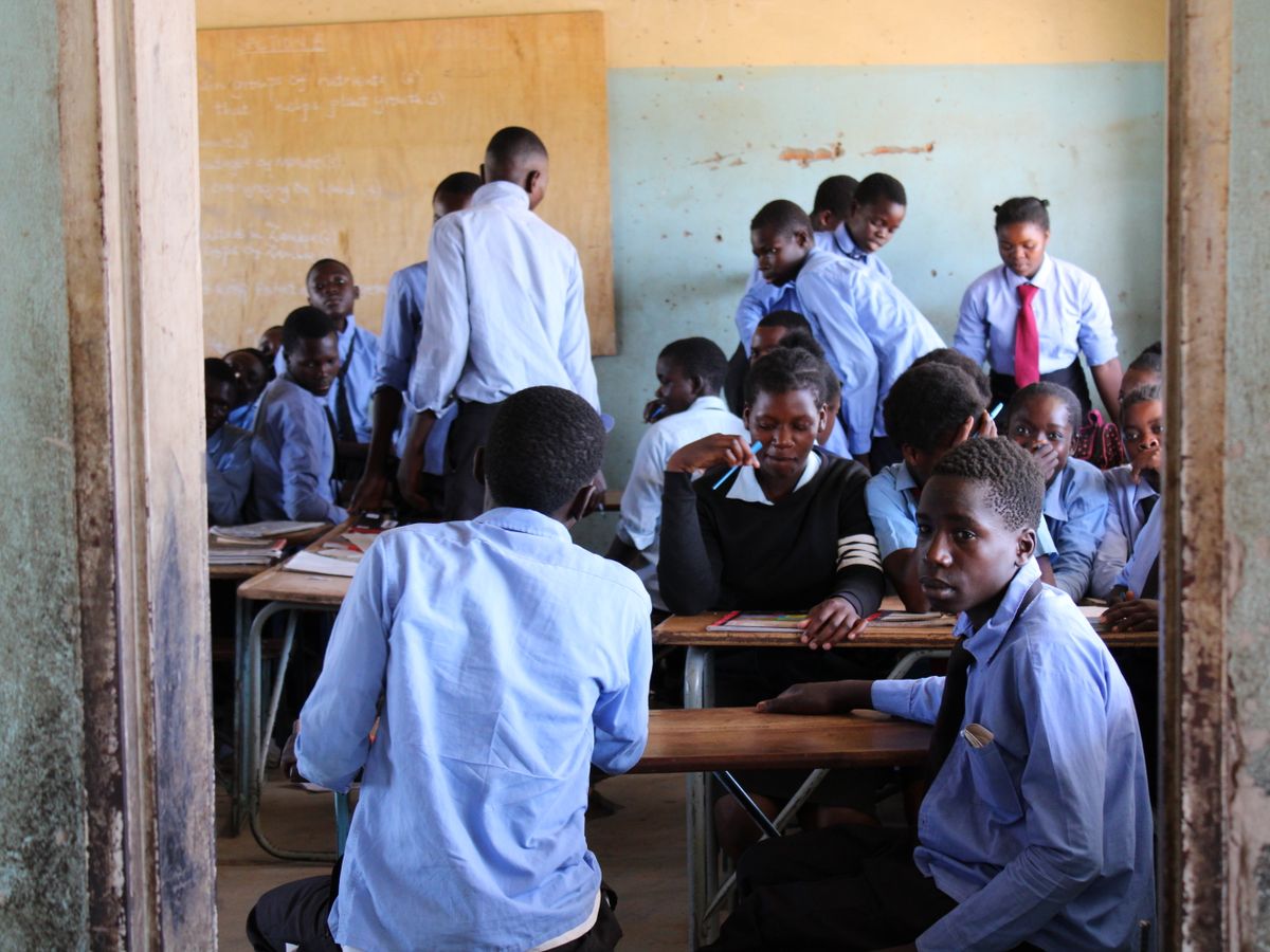 Pupils in uniform at their desks in a classroom